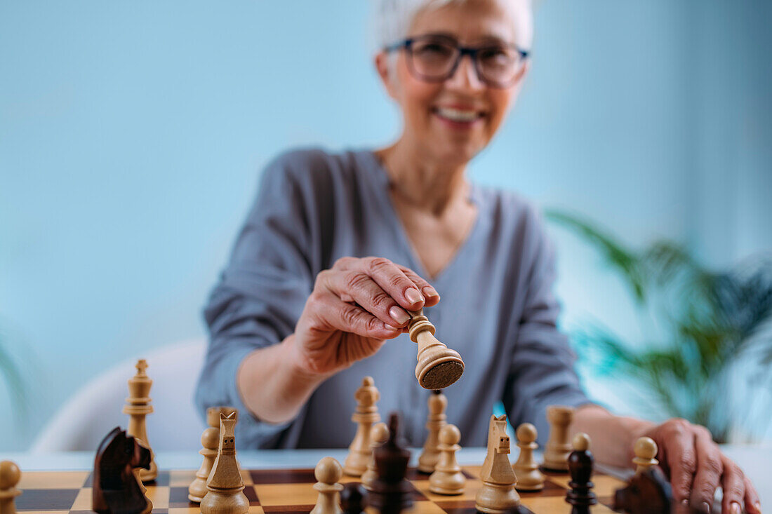 Senior woman playing chess