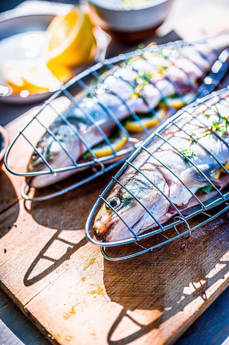 Fresh trout with lemon and herbs in the fish grilling baskets