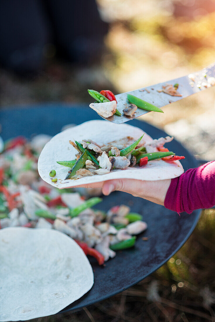 Person preparing tortilla