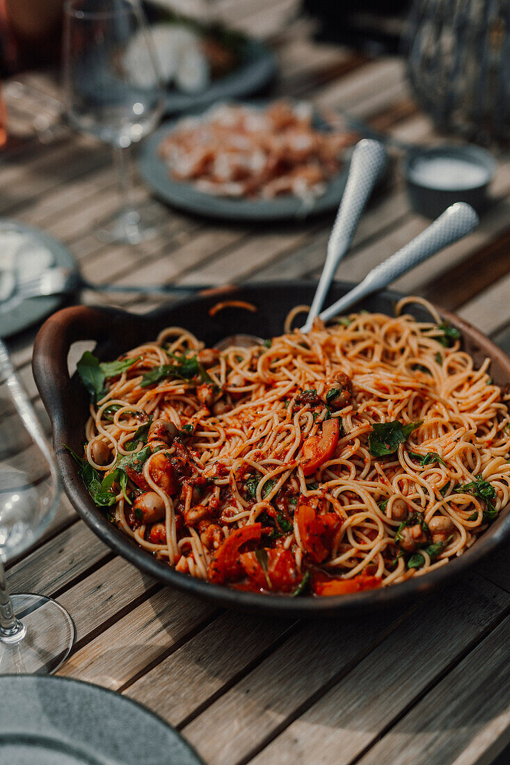 Spaghetti with tomatoes sauce on table