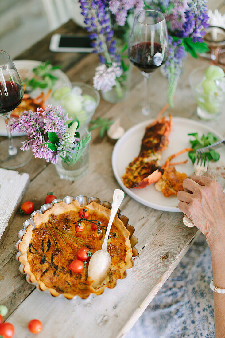 Savory tart with cherry tomatoes on table