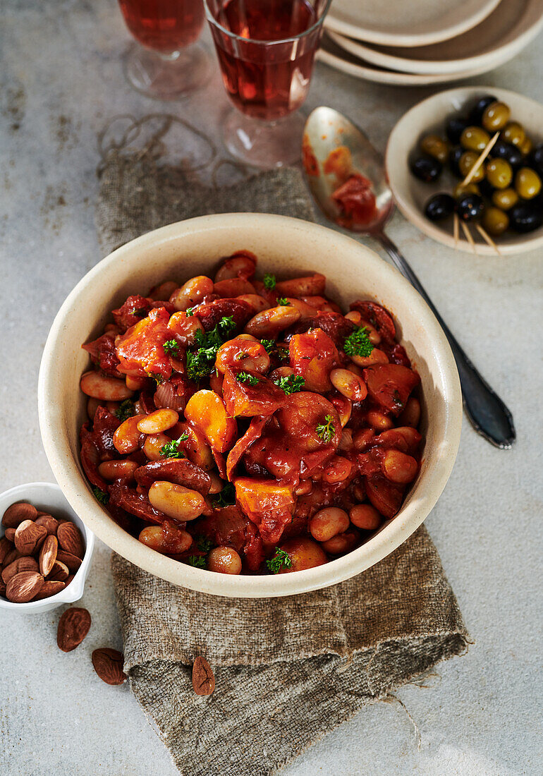 White bean stew with mixed olives and almonds