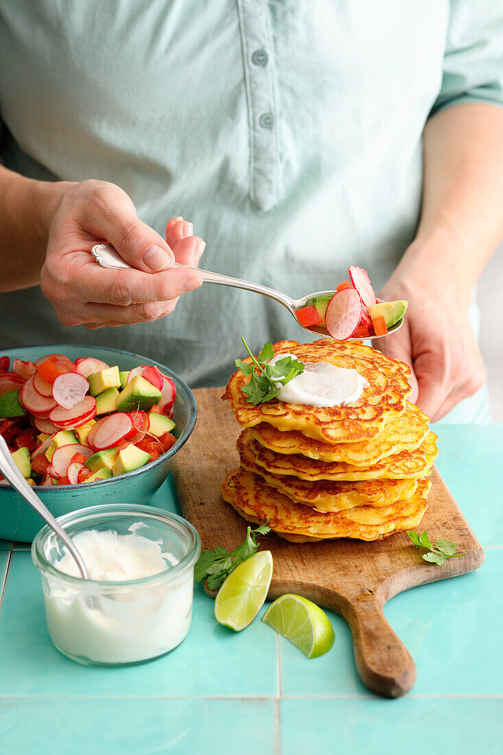 Vegetarian corn pancakes with an avocado and radish salad