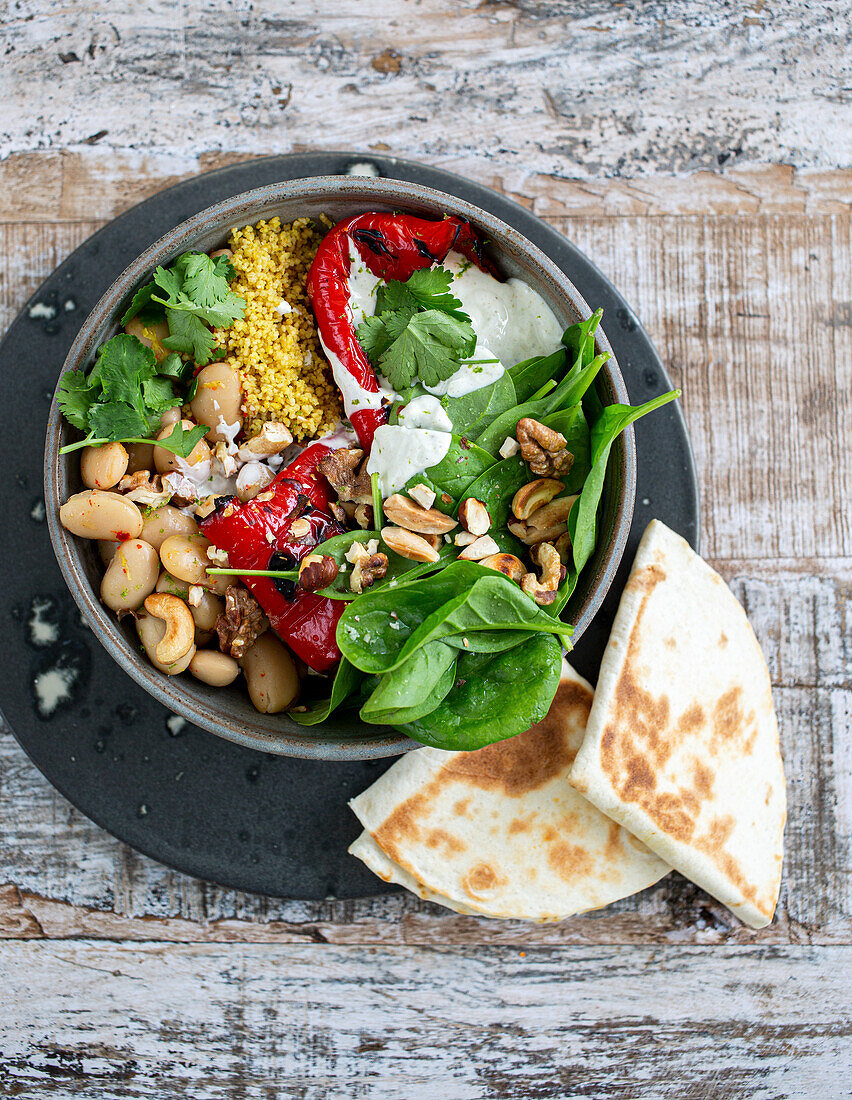Mezze bowl with grilled peppers, coriander yoghurt and cashew nuts