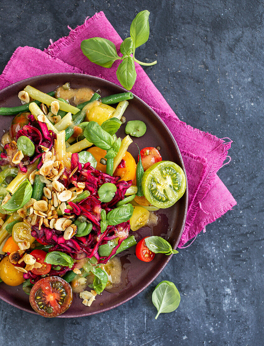 Colourful bean and tomato salad with red cabbage and roasted hazelnuts