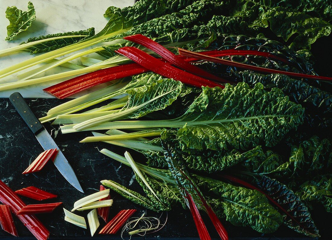 Red and green stalked chard on marble background