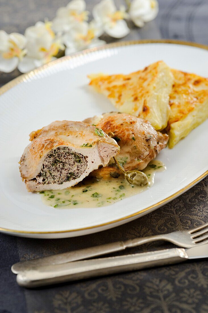Chicken cutlet with poppy seed stuffing served over caper sauce
