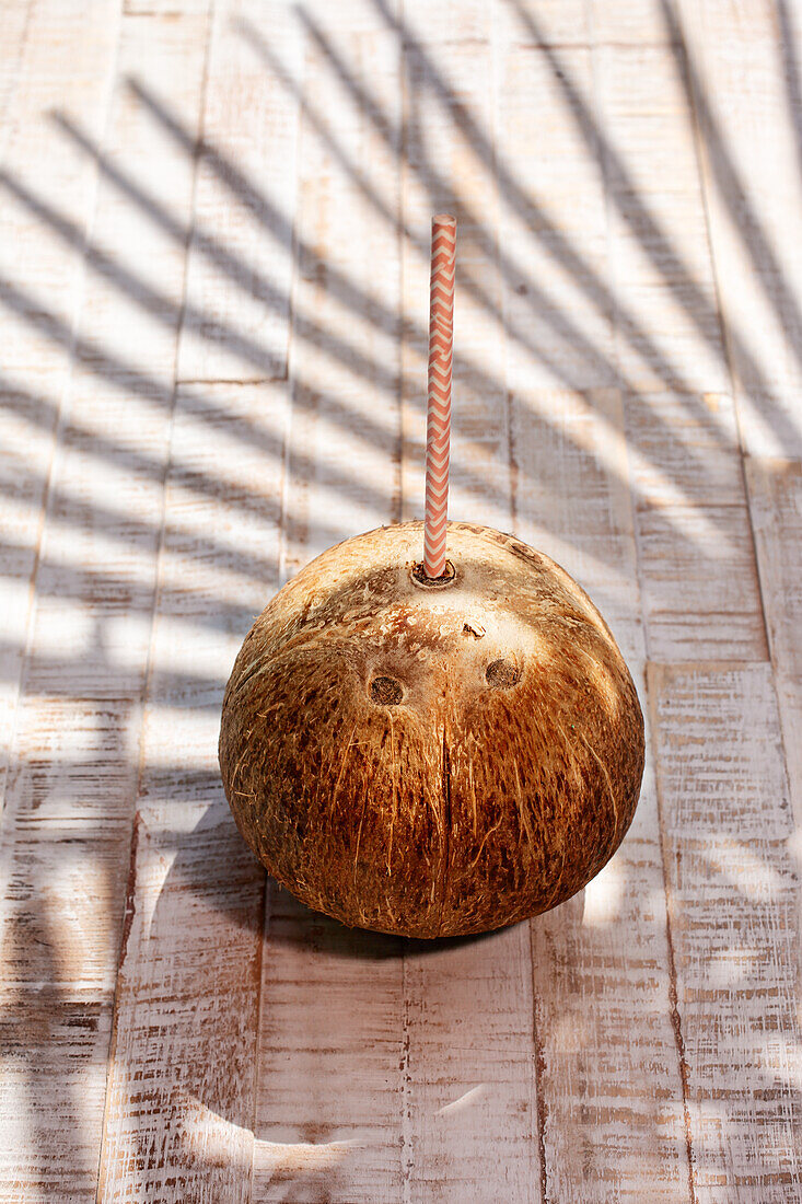 Coconut with paper drinking straw