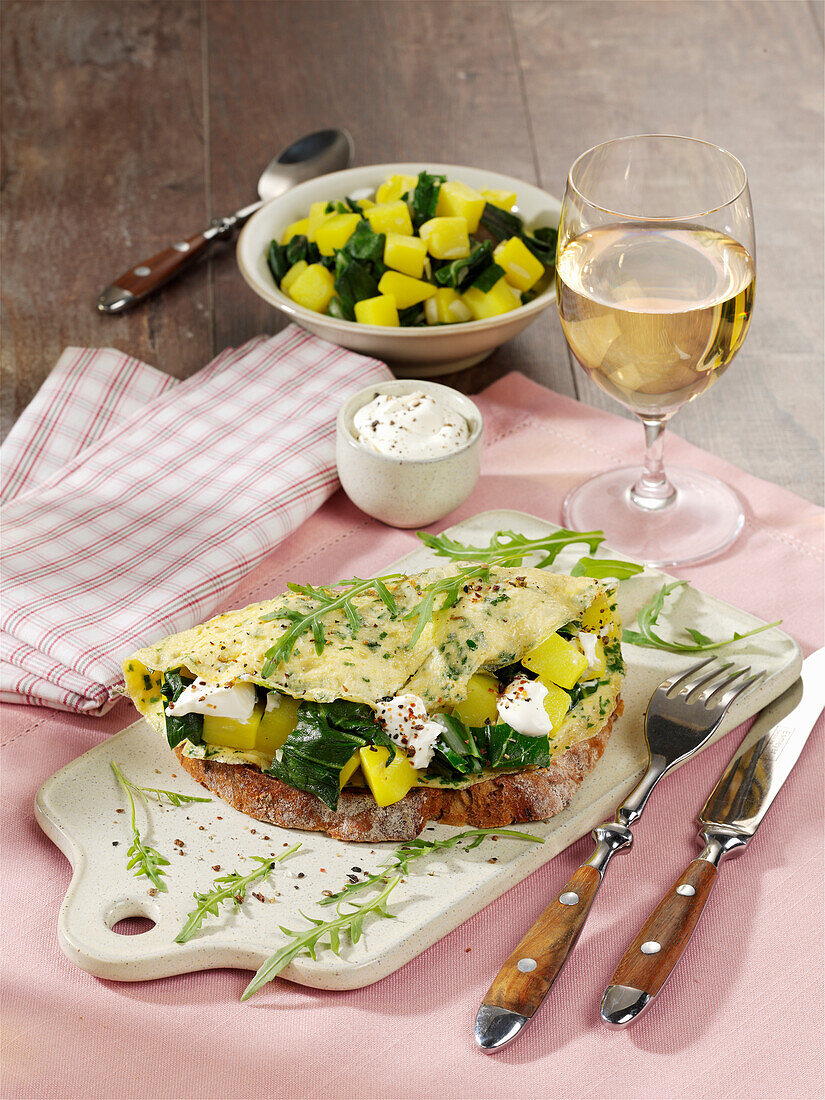 Spicy omelette with potatoes and chard on farmhouse bread