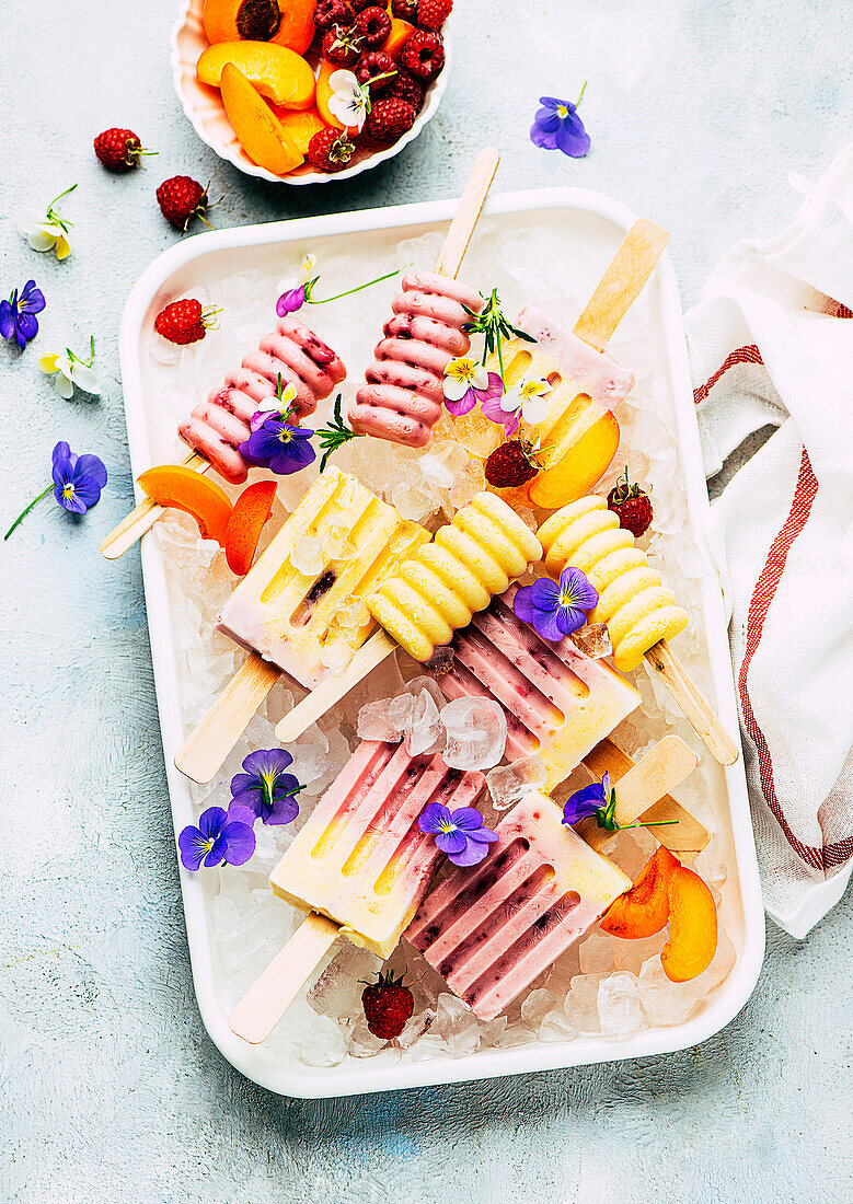 Raspberry and apricot ice cream popsicles