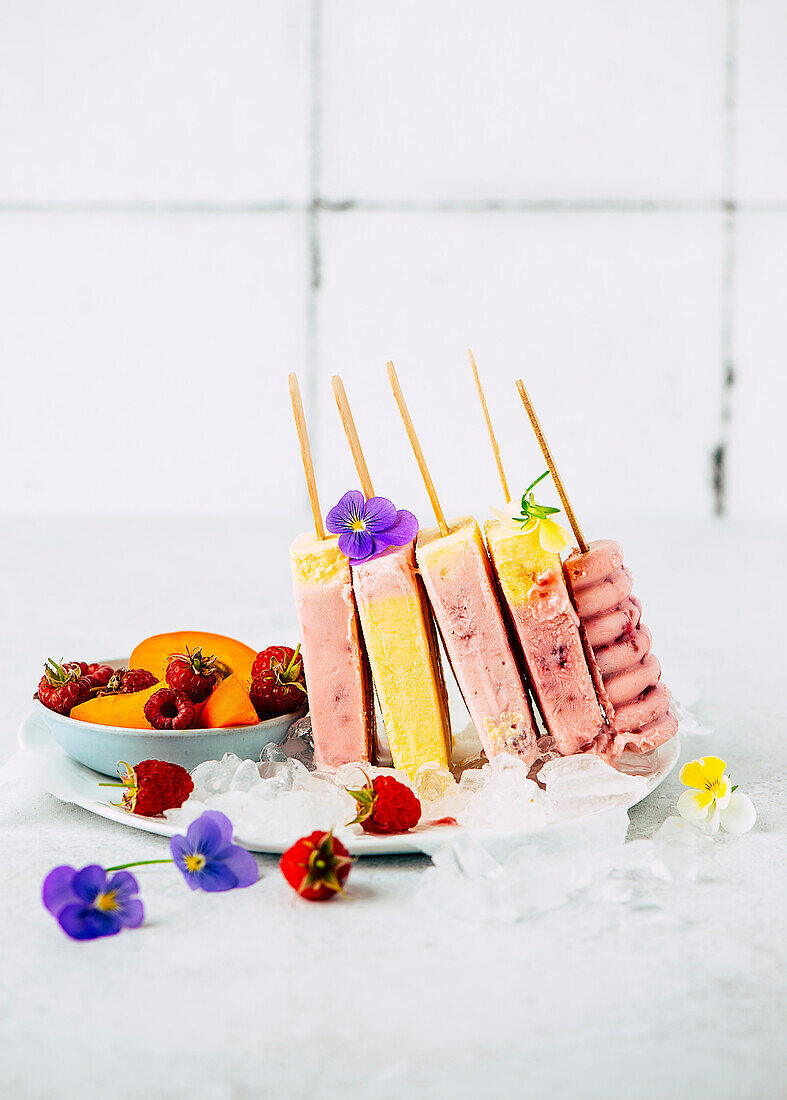 Raspberry and apricot ice cream on a stick