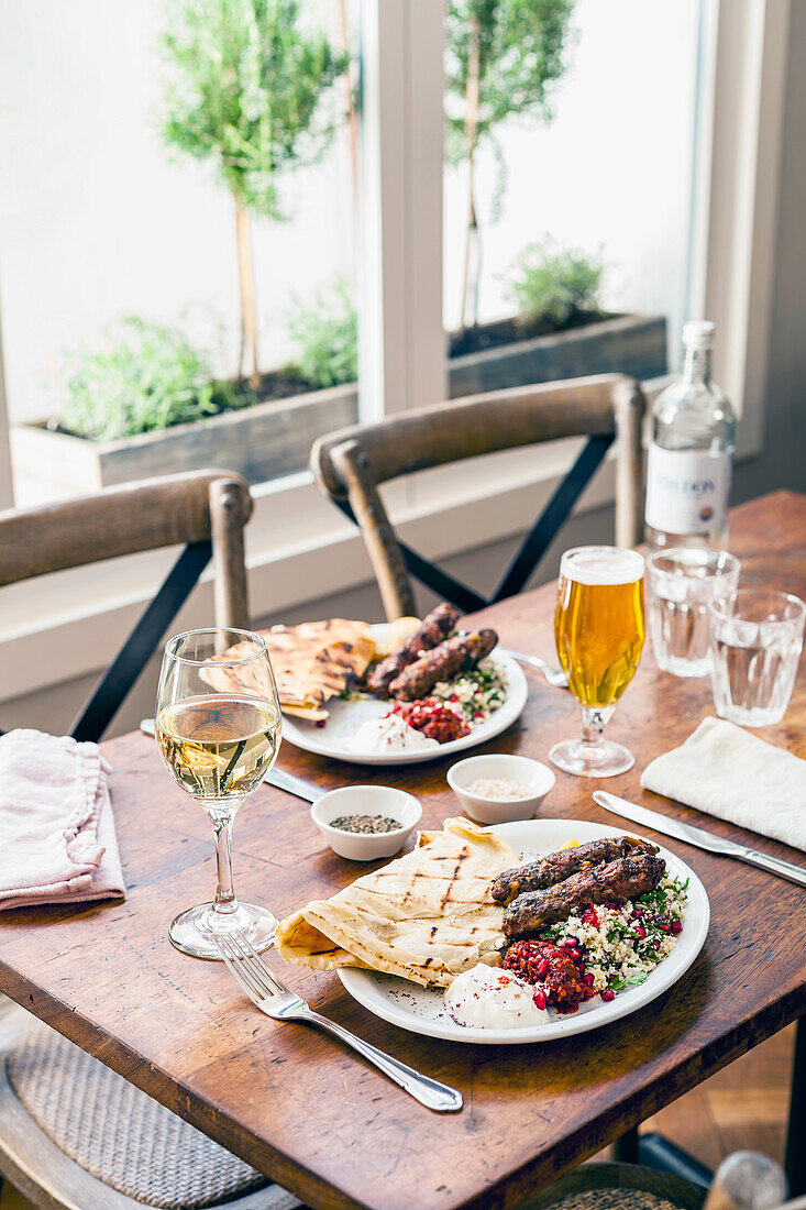 Venison and mutton kofte, cauliflower couscous, flatbread and harissa