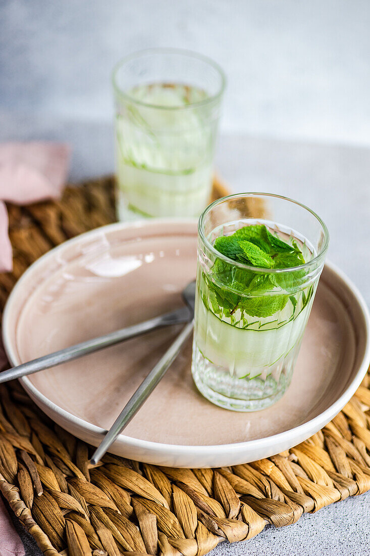 Glasses with detox cucumber water served on the table in sunny day