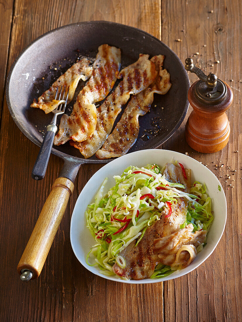 White cabbage and horseradish salad with pork belly strips