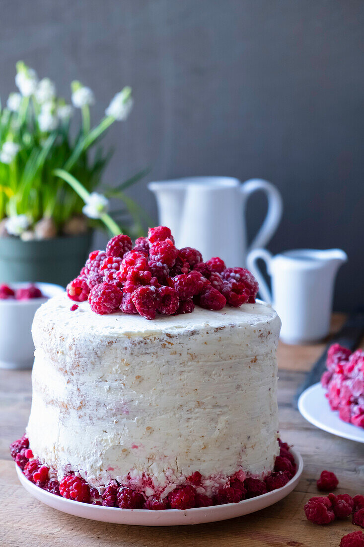 Sponge cake with buttercream frosting and raspberries