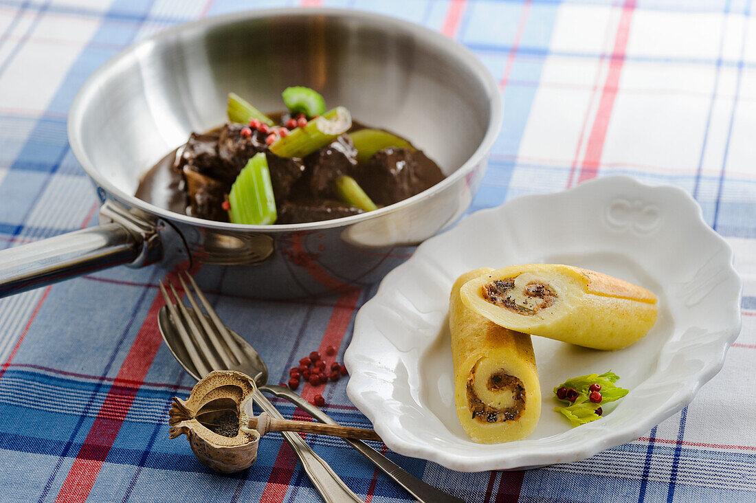 Sherry Braised pork shoulder with celery stalks and poppy-seed roulade