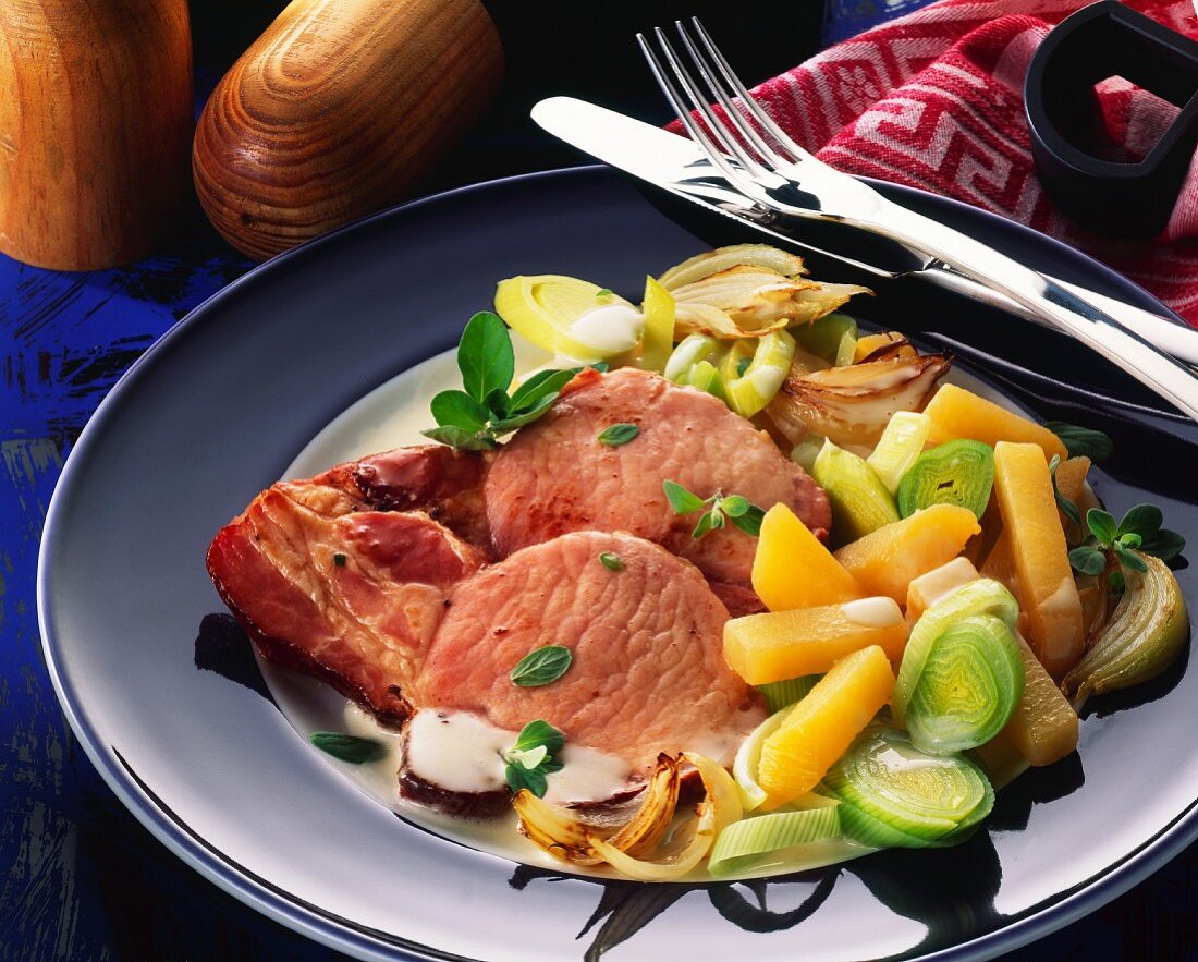 Slices of smoked pork rib with carrots & leeks & cream sauce