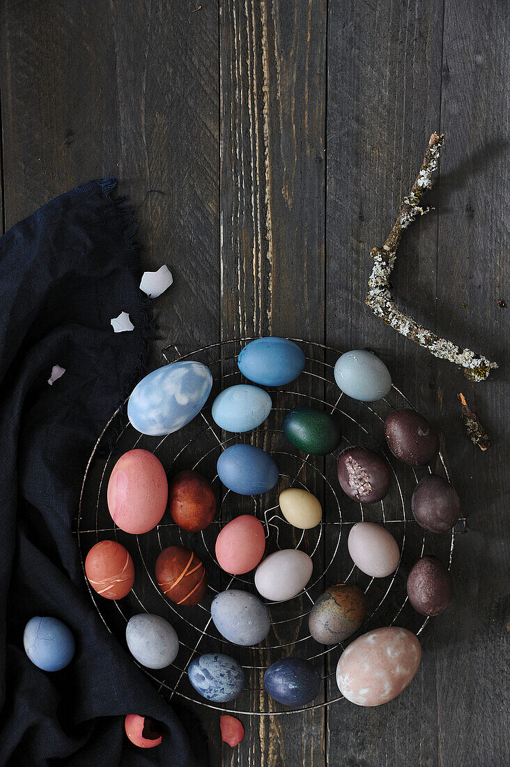 Easter eggs dyed with natural dyes, on wire rack