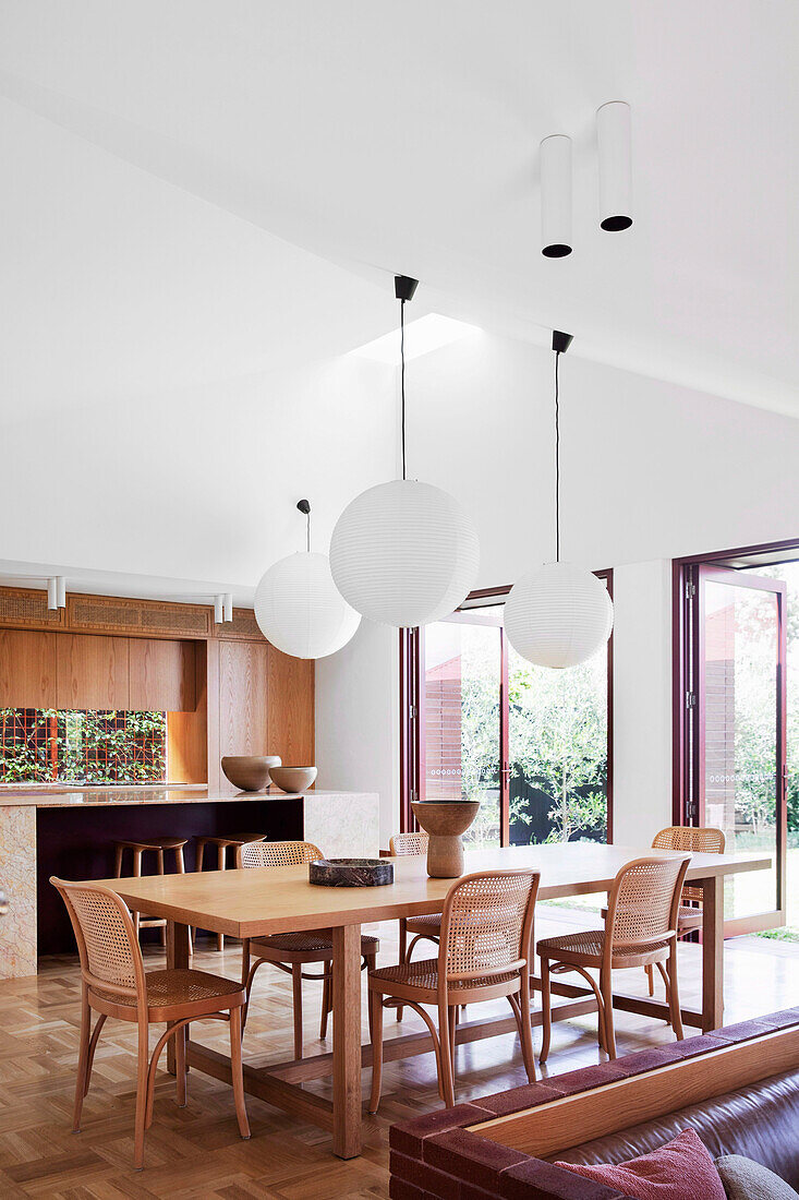 Dining area with sphere pendant lights in a bright, open living room