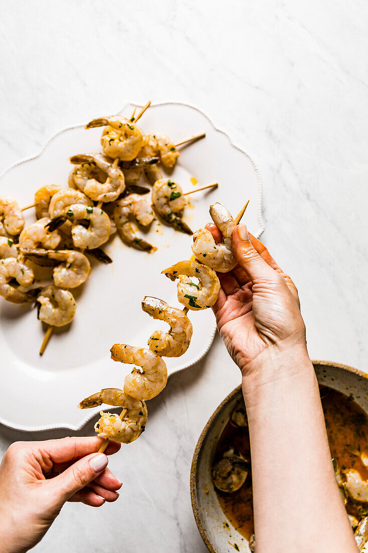 Shrimp skewers in a homemade marinade, on a marble background