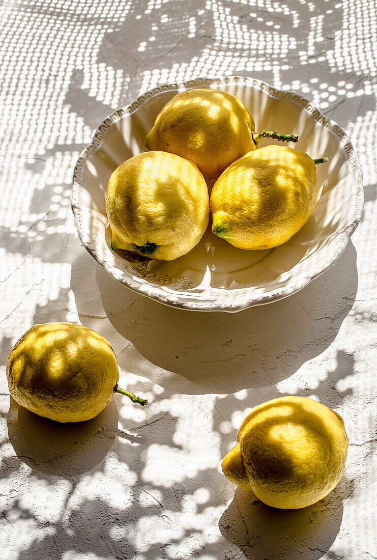 Lemons in a bowl in sunlight