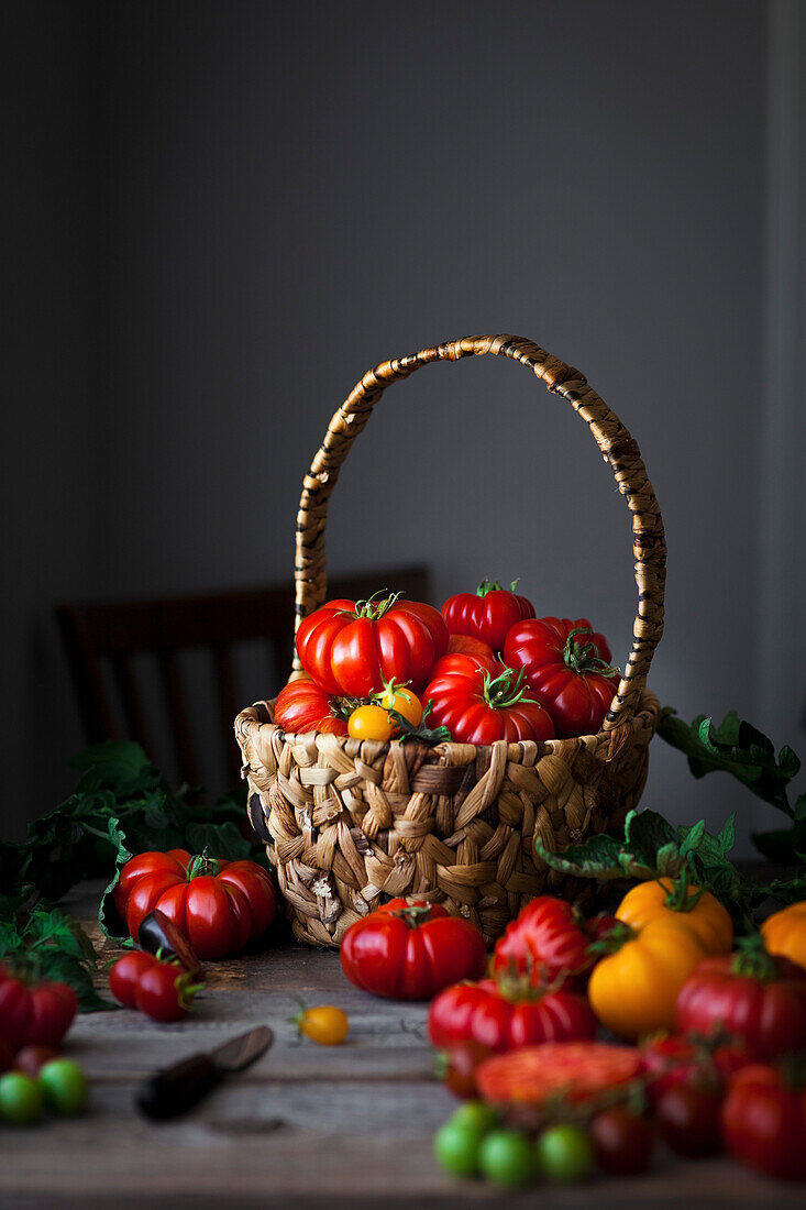 Wicker basket filled with heirloom tomatoes.