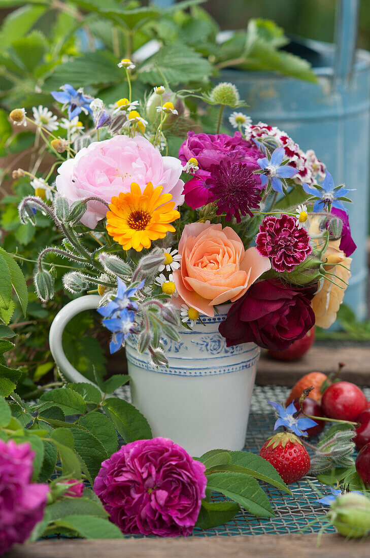 Small summer bouquet with roses, marigold, carnation, knautia, borage, sweet William, Love-in-a-Mist, and camomile