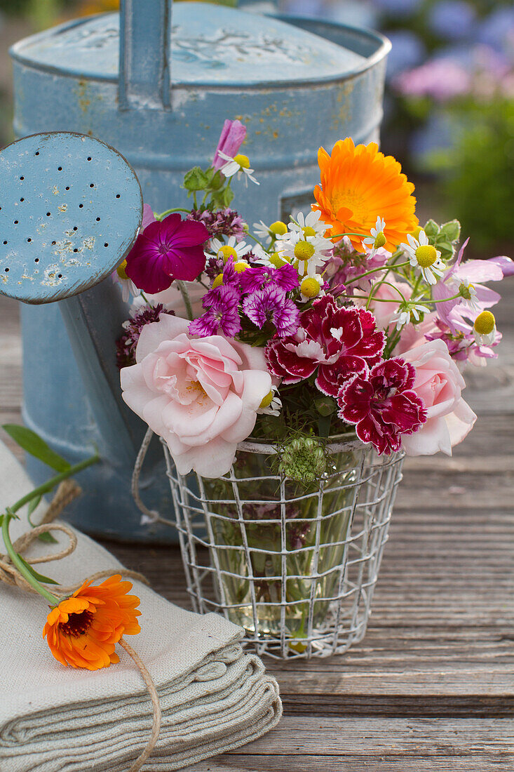 Small bouquet of roses, carnations, camomile, marigolds, coneflower, dost, mallow and crownvetch