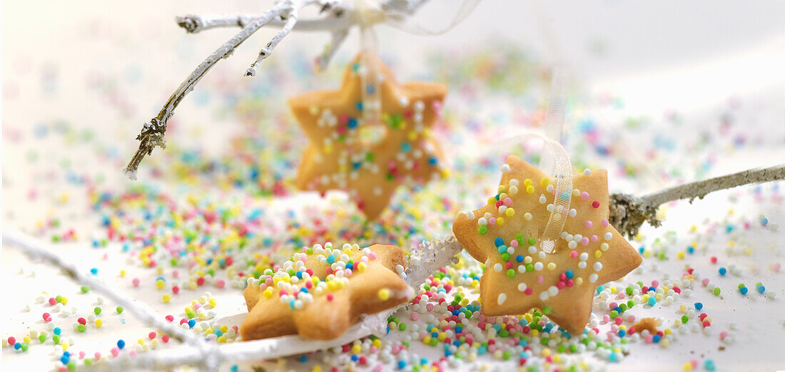 Christmas star biscuits with coloured sugar pearls
