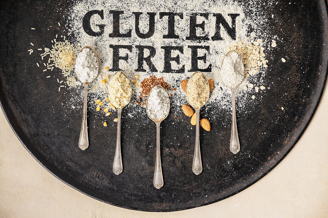 Gluten free written in flour and spoons of various gluten free flour