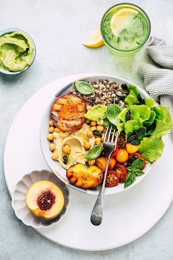 Summer bowl with grilled peach and hummus