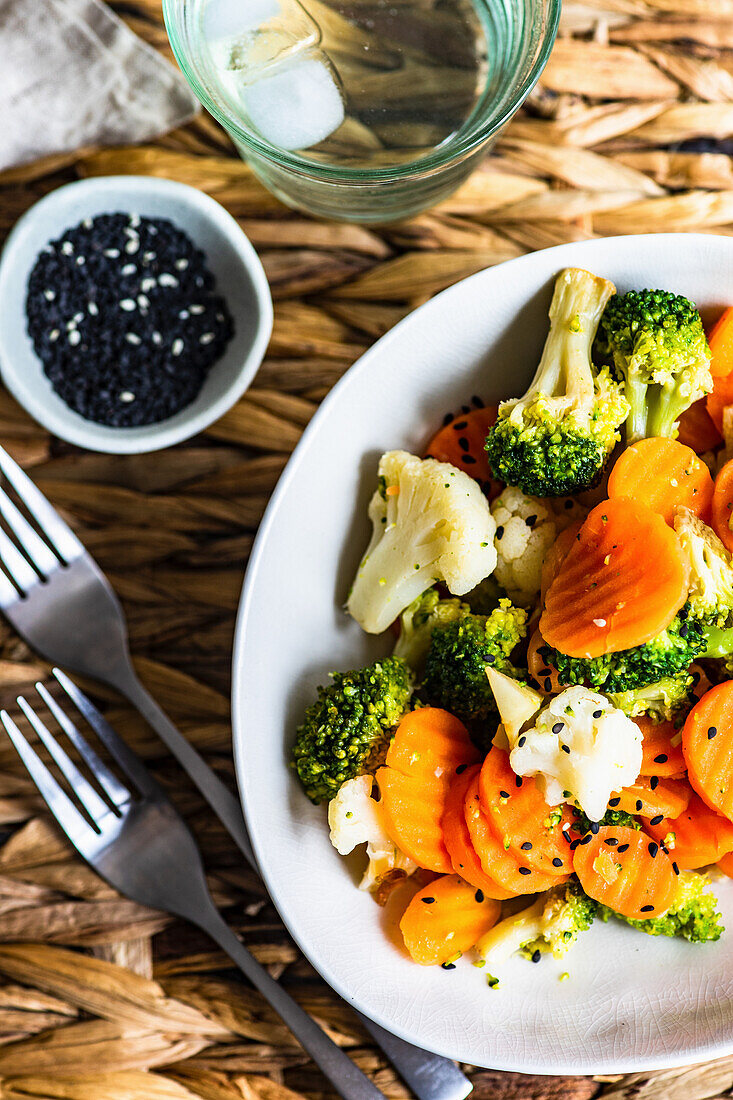 Summer healthy vegetable baked in the bowl with sesame seeds