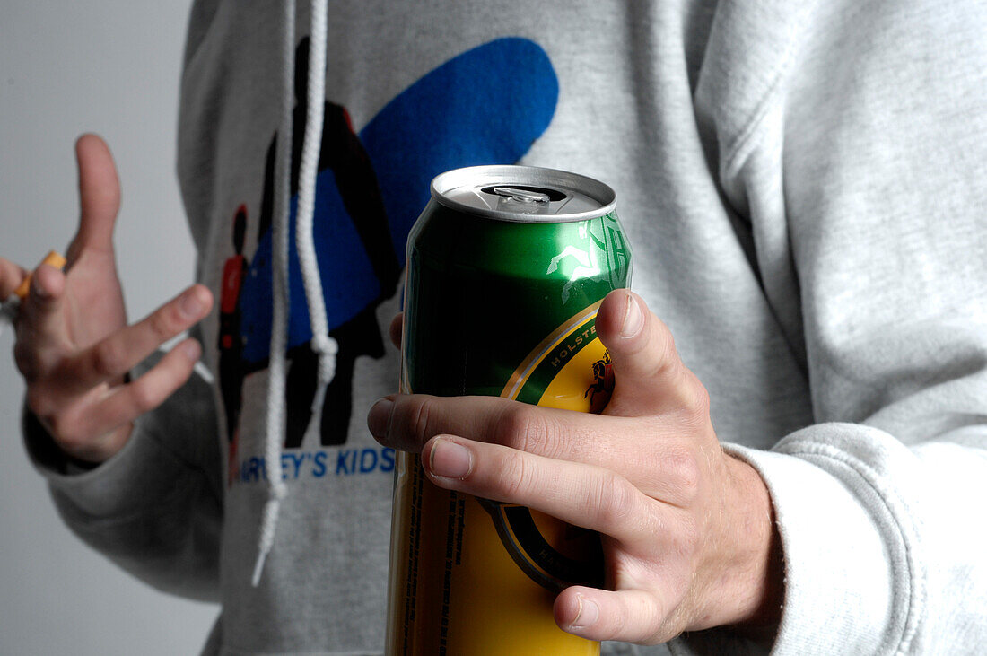 Man holding beer can and cigarette