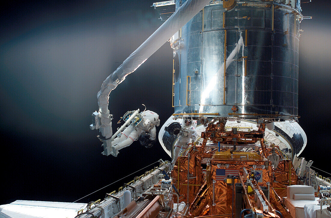 NASA astronauts servicing the Hubble Space Telescope