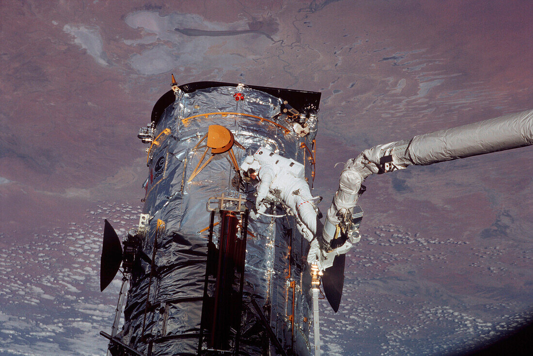 Astronaut Michael Massimino removing old solar array