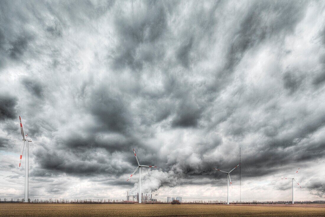 Wind turbines in front of a coal-fired powerplant