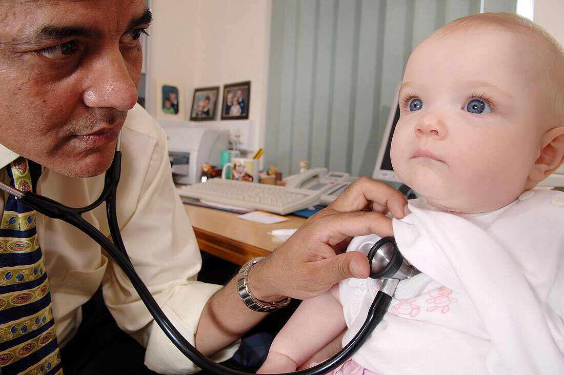 GP listening to a baby's heartbeat