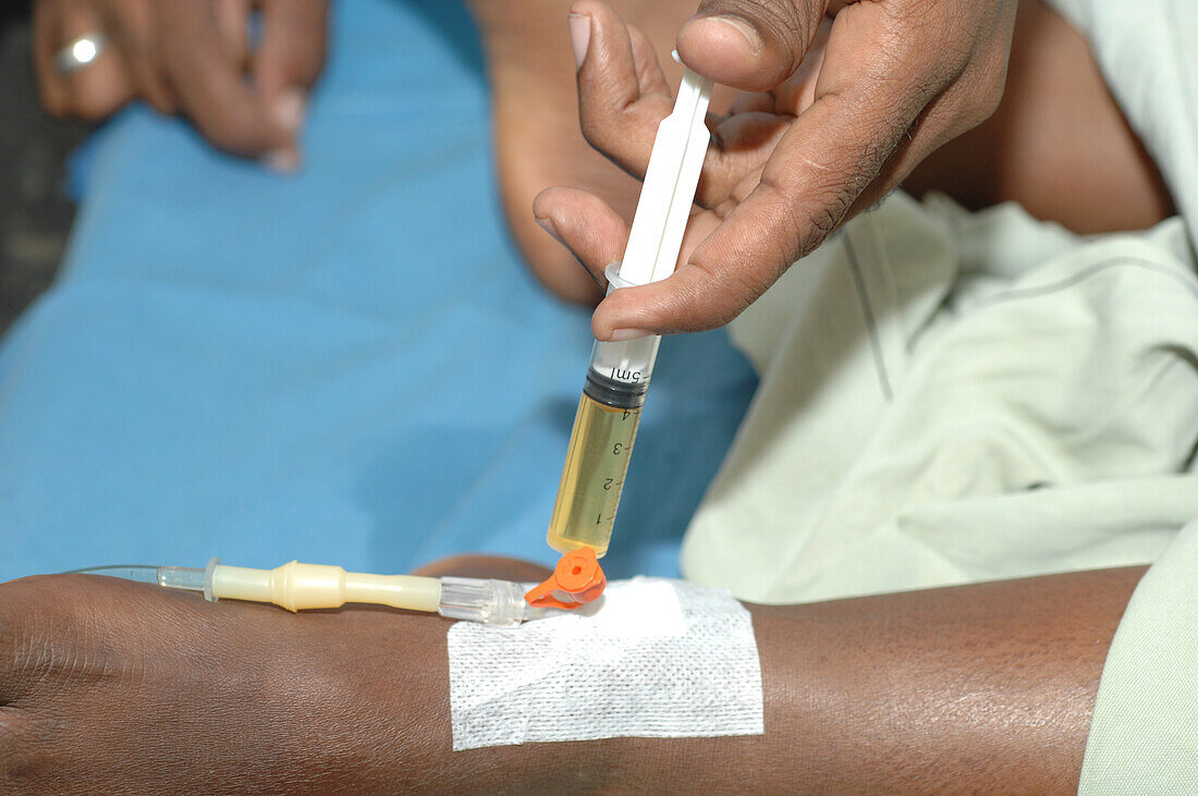 Nurse administering drugs through a cannula