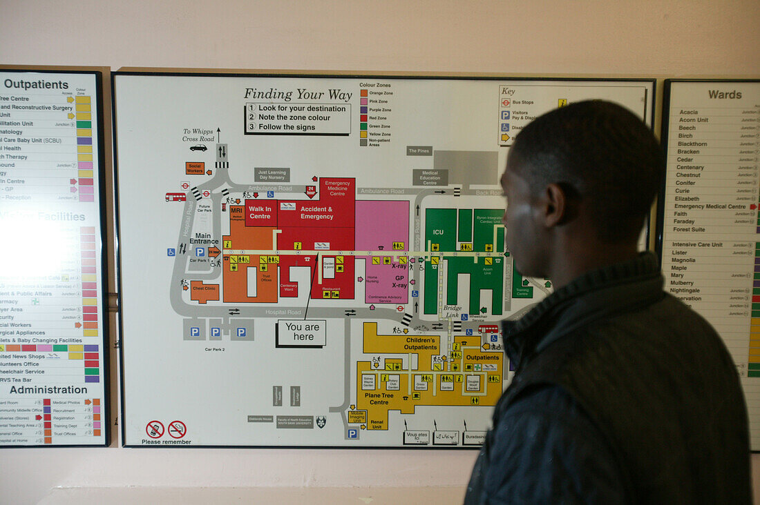 Young man reading a hospital map