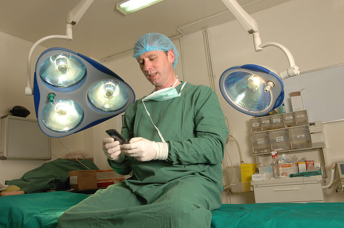 Surgeon using his mobile phone