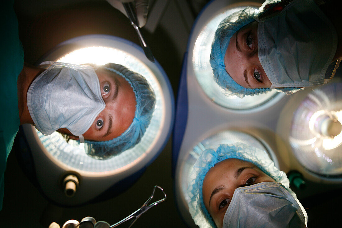 Patients view of surgical team operating under theatre lights