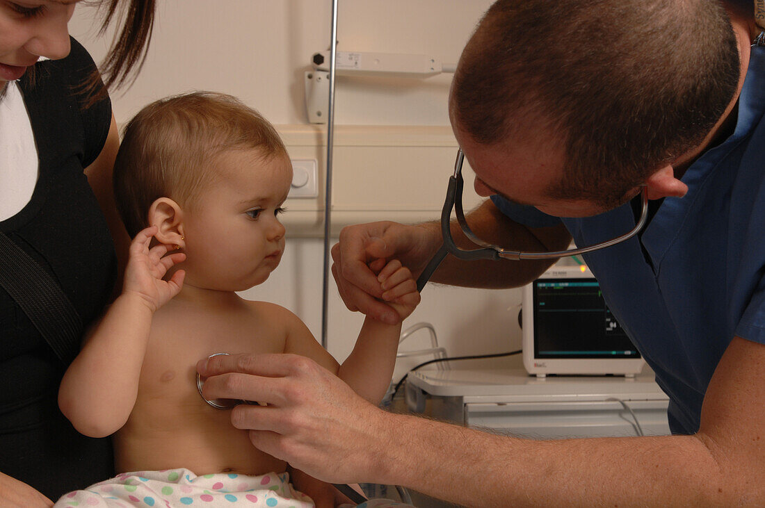 Paediatrician checks a baby's heart beat