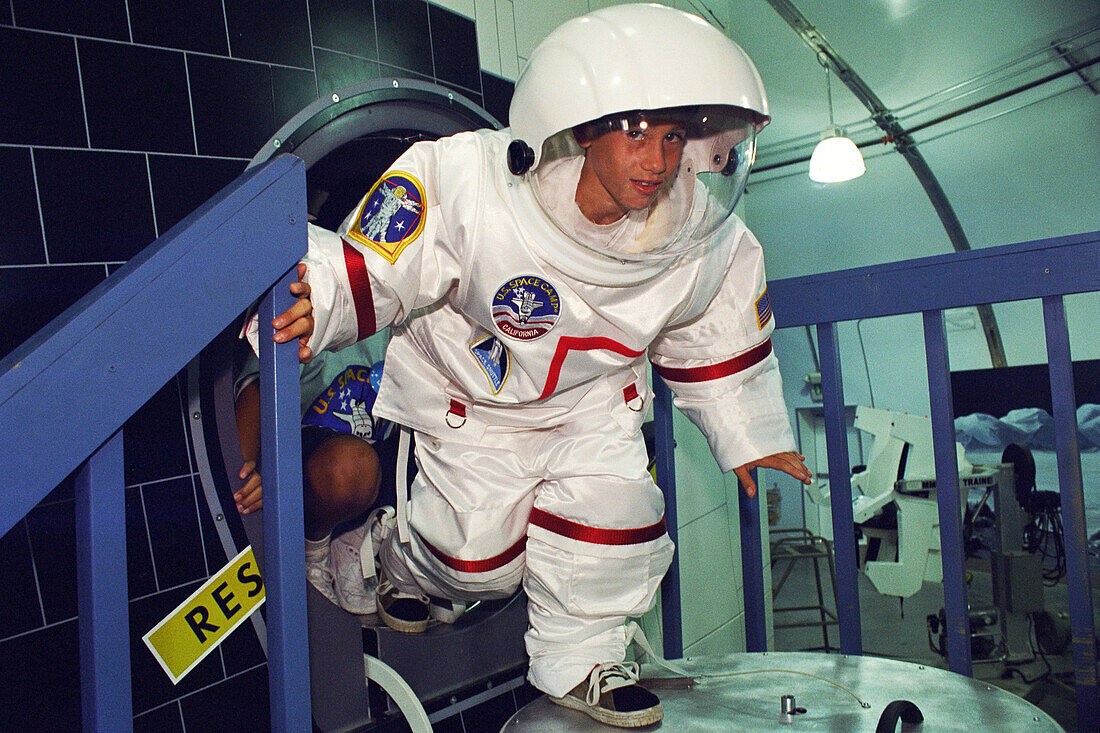 Student wearing a space suit at space camp