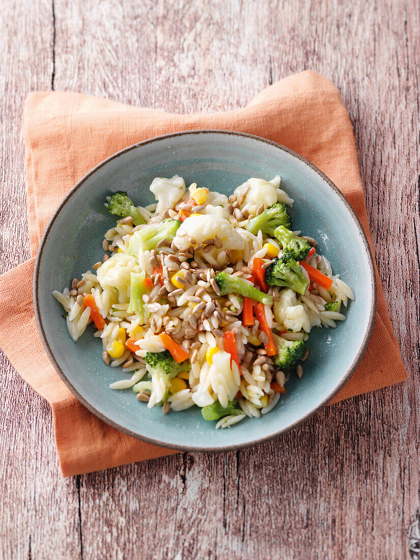 Rice noodle and vegetable risotto with sunflower seeds