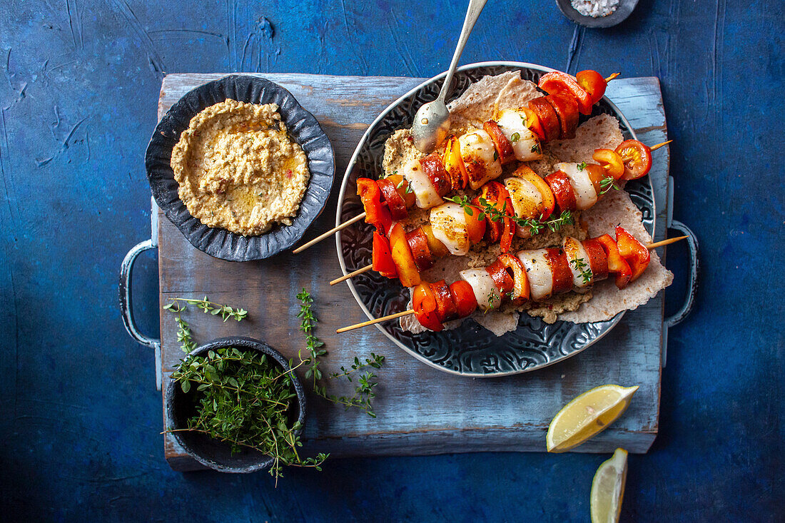 Grilled scallop and chorizo skewers with hummus