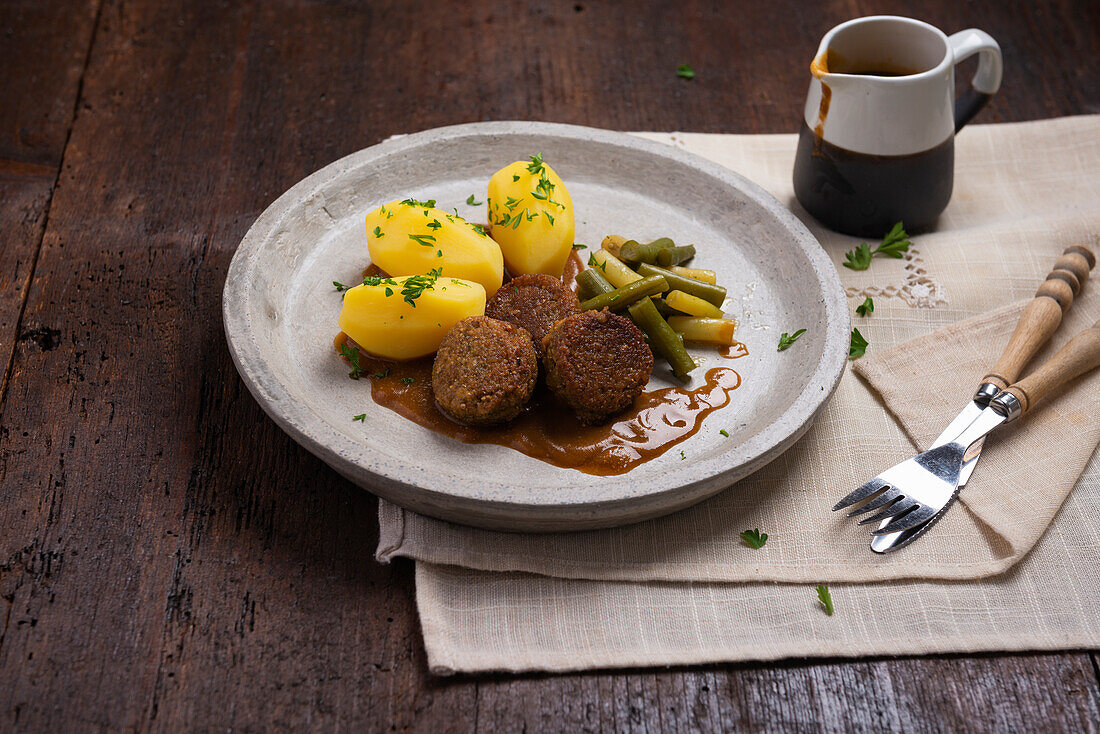 Vegane Falafel mit Kartoffeln, gelben und grünen Bohnen und Sauce