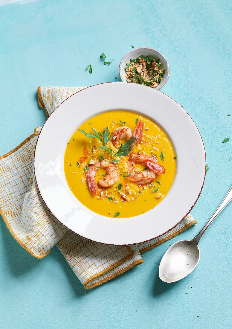 Carrot-coconut soup with ginger and prawns