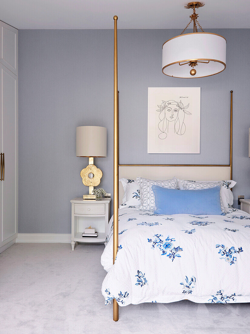 Double bed in bedroom with light grey wall