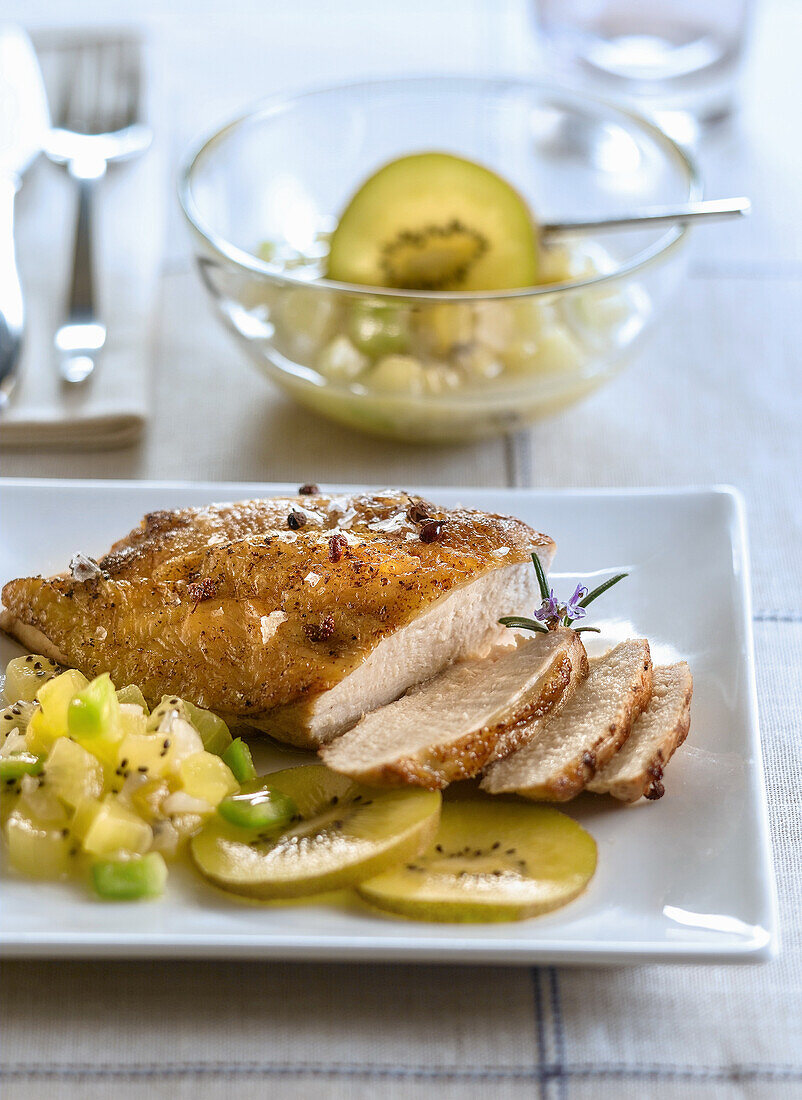 Fried chicken breast with kiwi salad