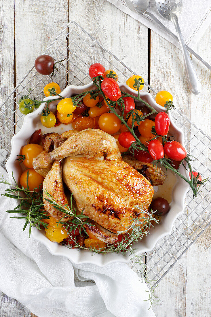 Roast chicken on coloured tomatoes